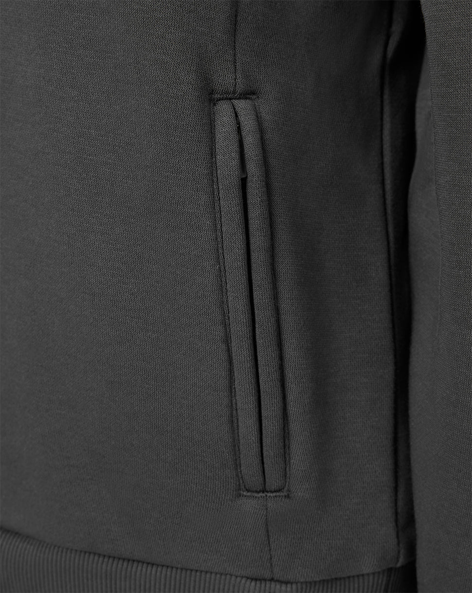 Close-up of a dark charcoal gray knit garment showing a vertical zippered pocket seam and ribbed hem.
