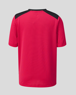 Red sports jersey with black sleeves on a gray background
