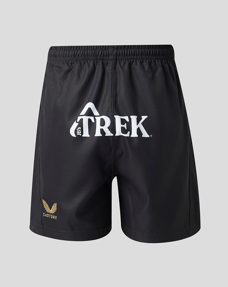 Black athletic shorts with a white Trek logo on the front and a small gold winged logo on the lower left leg, shown against a light gray background.