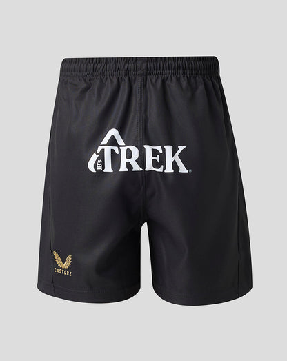 Black athletic shorts with a white Trek logo on the front and a small gold winged logo on the lower left leg, shown against a light gray background.