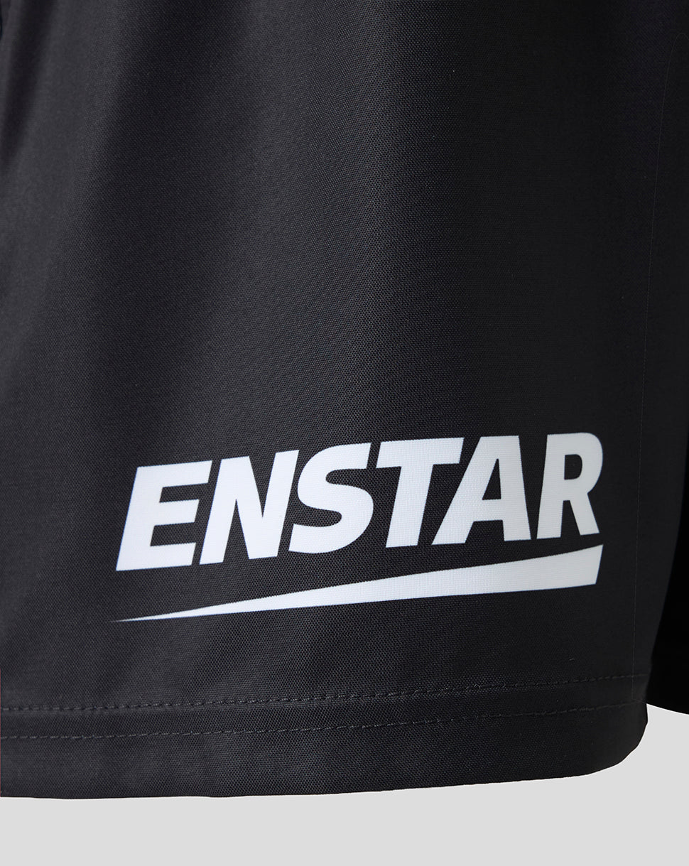 Close-up of a black athletic garment, likely shorts, featuring a bold white 'ENSTAR' logo printed across the lower front.