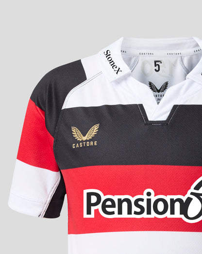 Close-up of a Castore rugby jersey with a red, white, and black horizontal color-blocked design, featuring a gold winged logo and a large red and white 'Pension' sponsor logo on the front.