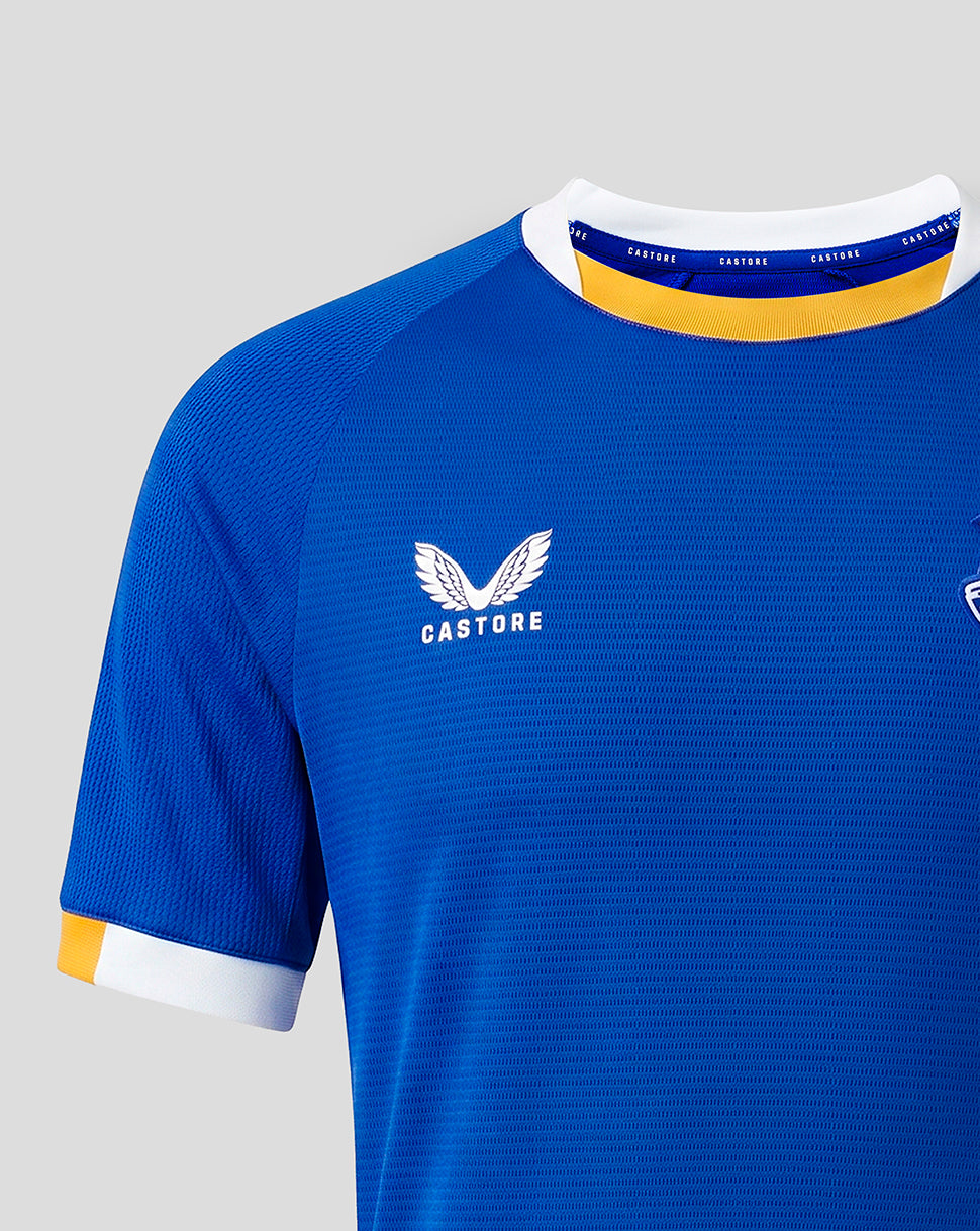 Blue Everton FC junior home short sleeve shirt close up of chest with Castore logo and white collar with yellow trim.