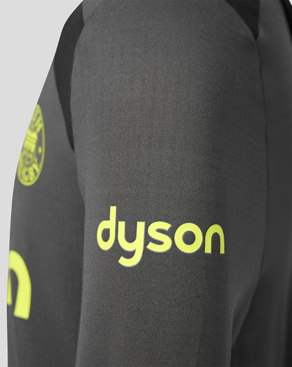 Close-up of a dark gray athletic jacket sleeve featuring a bright yellow-green 'dyson' logo printed on the front and part of a circular logo on the upper arm.