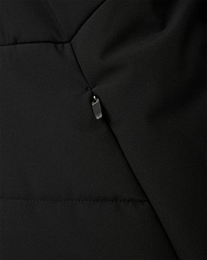 Close-up of a black quilted puffer jacket showing a diagonal seam and a small silver zipper pull.