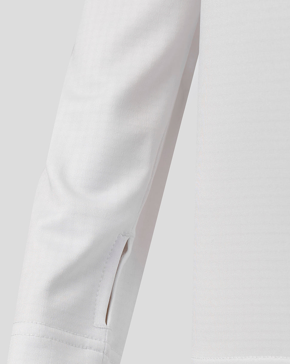 Close up of white Harlequins junior matchday quarter zip sleeve and zip placket