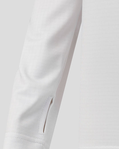 Close up of white Harlequins junior matchday quarter zip sleeve and zip placket