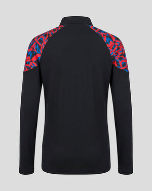 A black long-sleeve athletic pullover with a red and blue abstract patterned yoke on the shoulders, shown from the back against a light gray background.