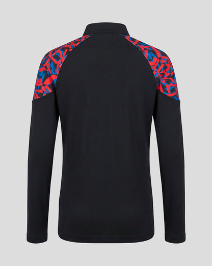A black long-sleeve athletic pullover with a red and blue abstract patterned yoke on the shoulders, shown from the back against a light gray background.