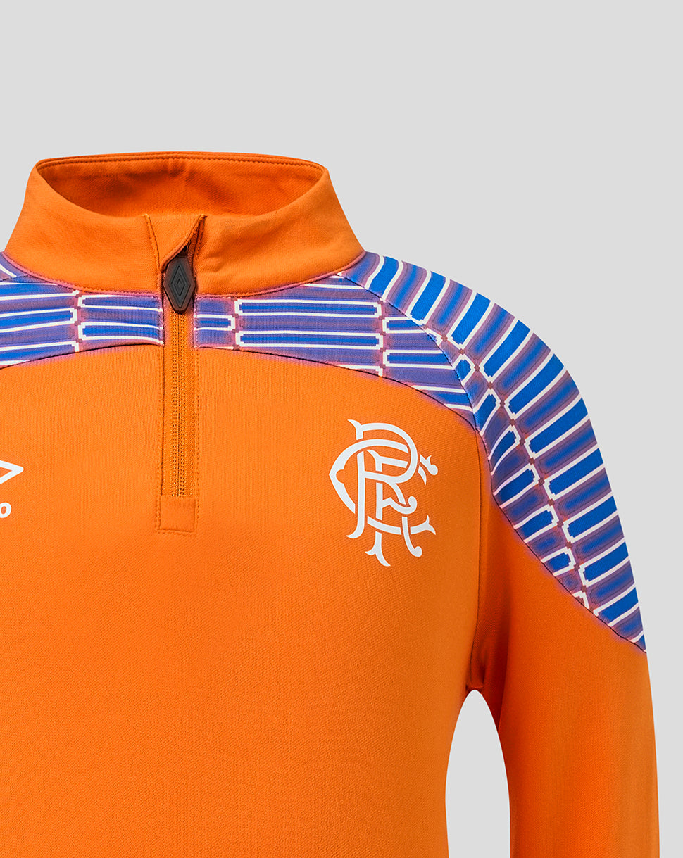 Close-up of an orange long-sleeve quarter-zip athletic top with blue and white striped shoulder panels and a white Rangers FC crest on the chest, shown against a light gray background.