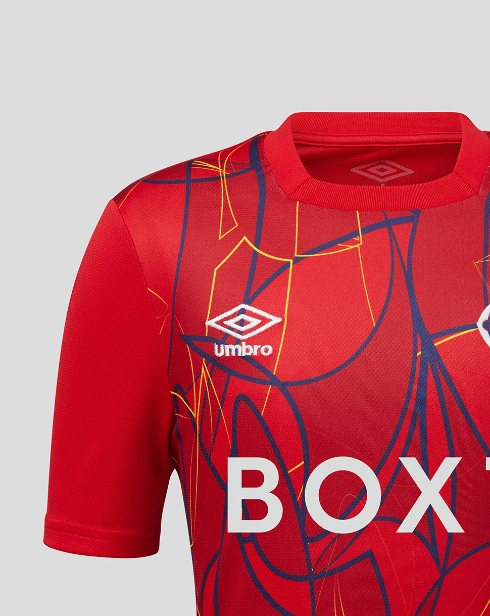 Close-up of the red Rangers junior away goalkeeper jersey showing the Umbro logo and bold abstract pattern.