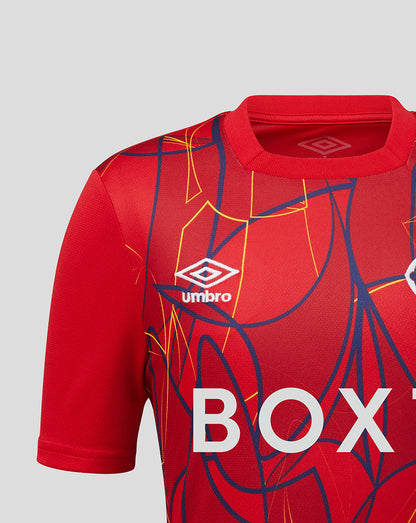Close-up of the red Rangers junior away goalkeeper jersey showing the Umbro logo and bold abstract pattern.