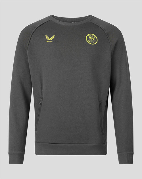 A dark gray crewneck sweatshirt with yellow embroidered accents, featuring the Castore logo on the right chest and a circular club crest on the left chest, displayed on a solid gray background.