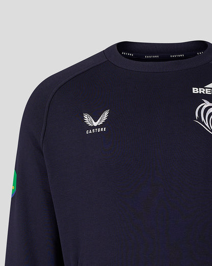 Close-up of navy travel sweatshirt front showing Castore logo and tiger crest with a sleeve patch
