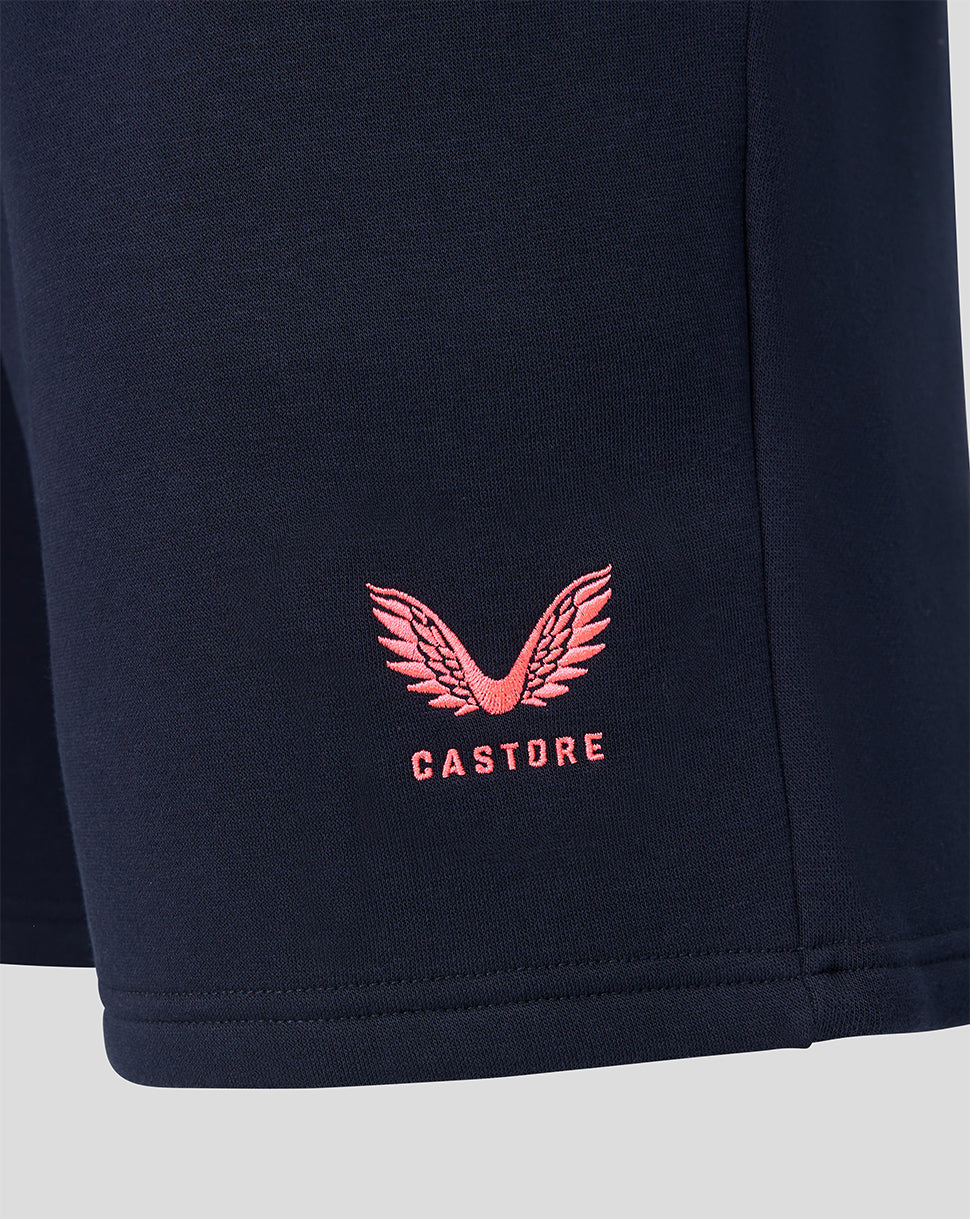 Pink Castore winged logo patch on navy shorts fabric