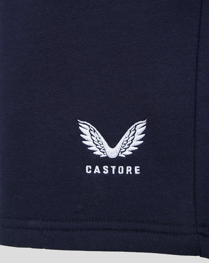 Navy fabric close up with white winged Castore logo embroidered on the shorts