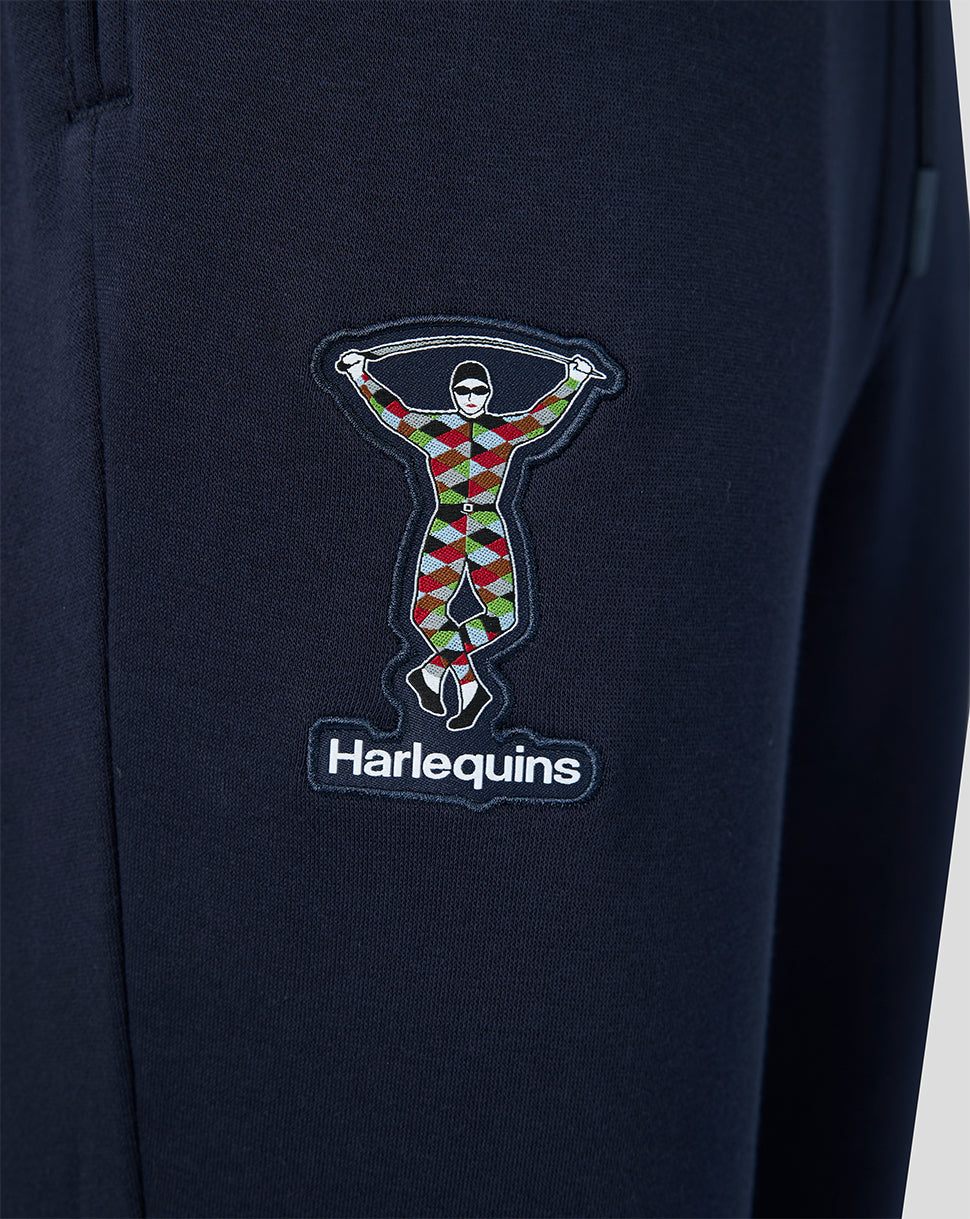 Navy jogger leg with a multicolor Harlequins emblem patch and logo beneath