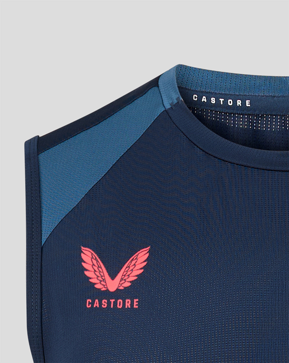 Navy blue athletic shirt with pink logo and 'Castore' branding on a light gray background