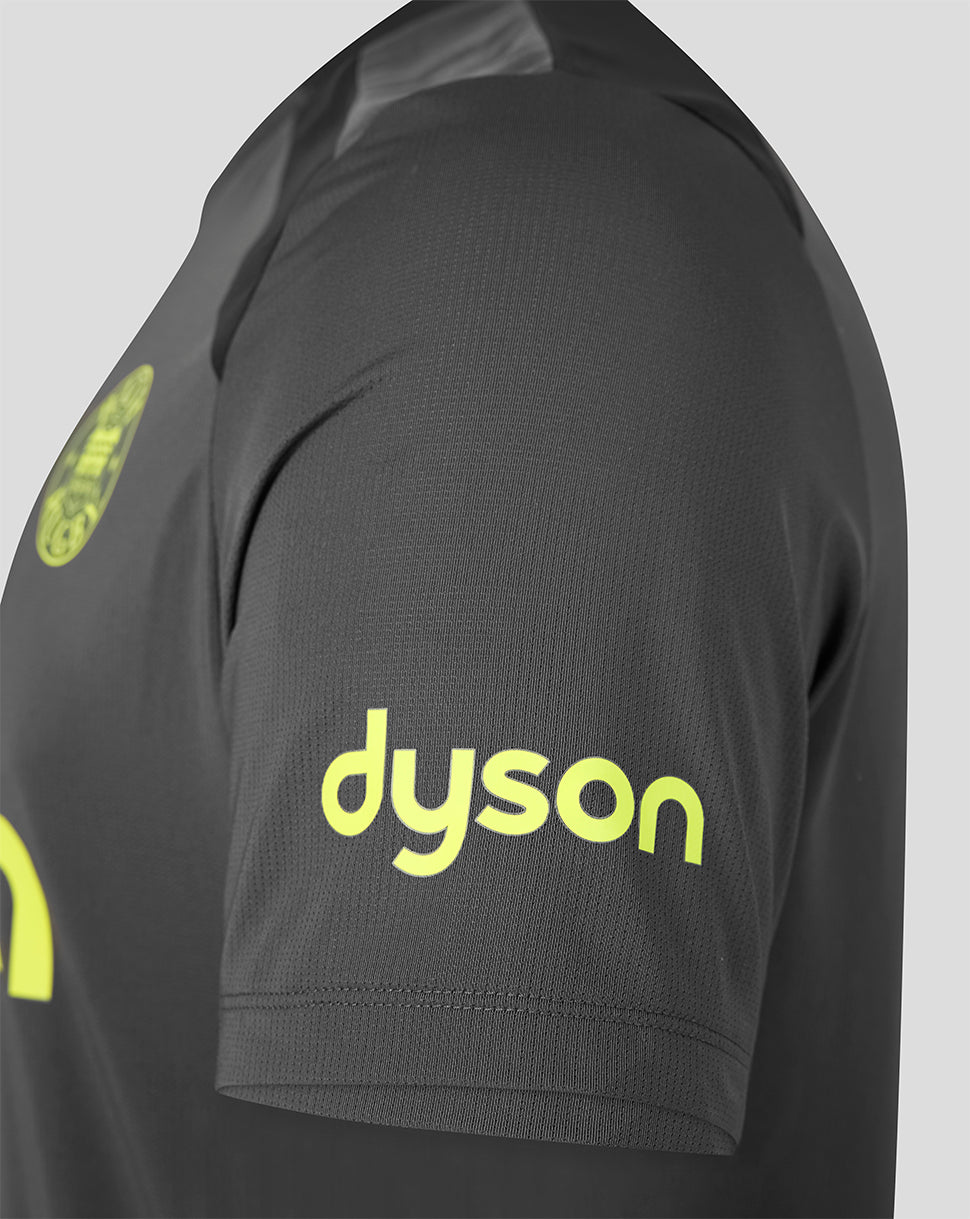 Close-up of a dark gray athletic jersey sleeve featuring a bright yellow-green 'dyson' sponsor logo on the upper arm.