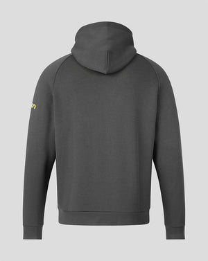 A dark gray pullover hoodie shown from the back, featuring a small yellow logo on the left sleeve, set against a solid light gray background.