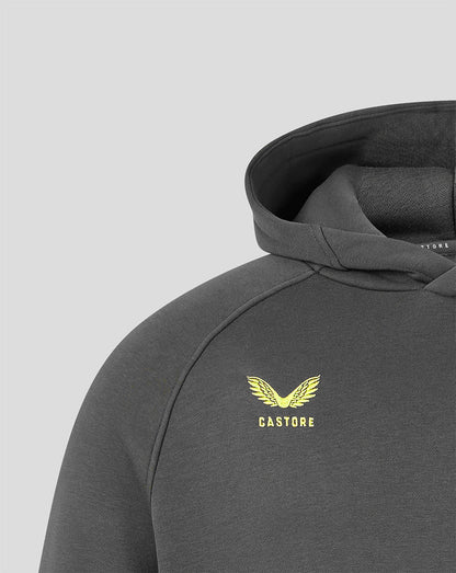 Close-up of a dark gray hooded sweatshirt with a yellow winged logo and the word 'CASTORE' printed on the chest, shown against a light gray background.