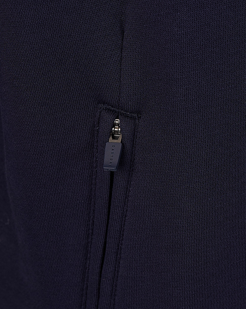Close up of navy hoodie zipper with Castore branded pull on a pocket.