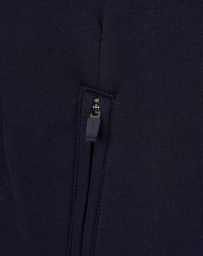 Close up of navy hoodie zipper with Castore branded pull on a pocket.