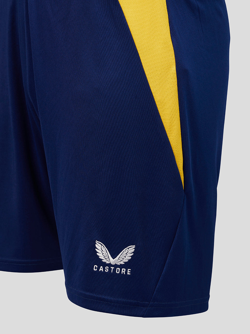 Navy shorts with a yellow stripe and Castore logo on a light gray background