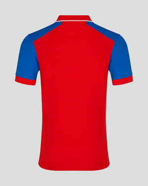 Back view of England Cricket short sleeve shirt in bold red with blue shoulder panels and white collar trim