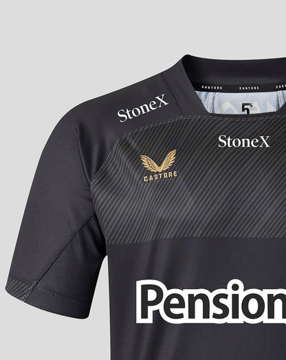 Close-up of a dark gray athletic jersey with diagonal textured striping, featuring 'StoneX' logos in white on both shoulders, a gold winged crest with 'CASTORE' on the right chest, and a large white 'Pension' logo at the bottom.