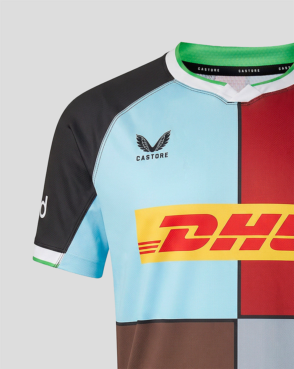 Close-up back shoulder of Harlequins 2026/27 home shirt showing blue and red panels and Castore neck branding