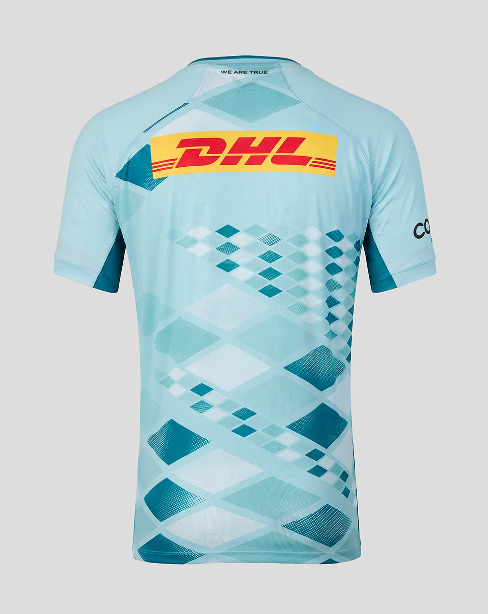 A light blue short-sleeve athletic jersey with a geometric diamond pattern in shades of blue and white, featuring a large yellow DHL logo on the back and a black 'CO' logo on the sleeve, shown against a solid gray background.