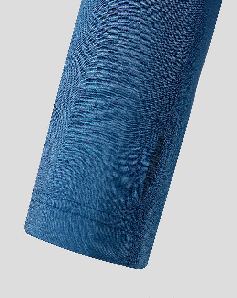 Close up of blue training top sleeve with dark navy shoulder panel