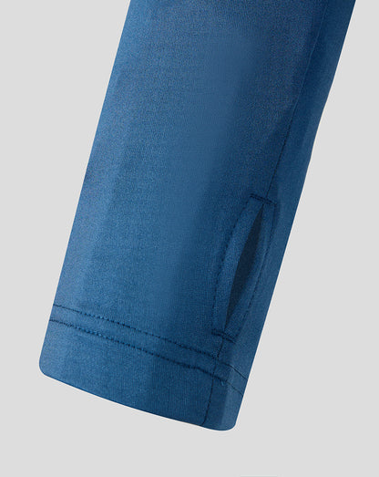 Close up of blue training top sleeve with dark navy shoulder panel