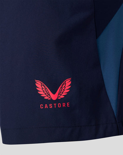 Close-up of navy training shorts fabric featuring a red Castore logo