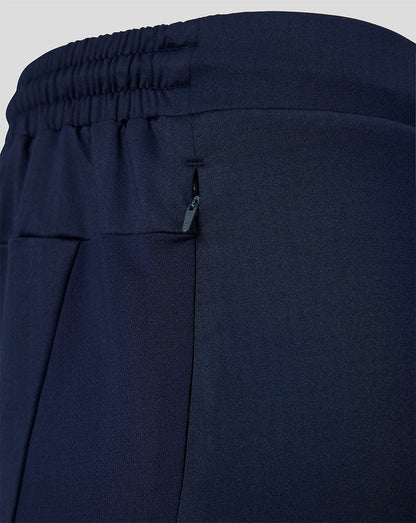 Navy blue pants with an elastic waistband on a light gray background
