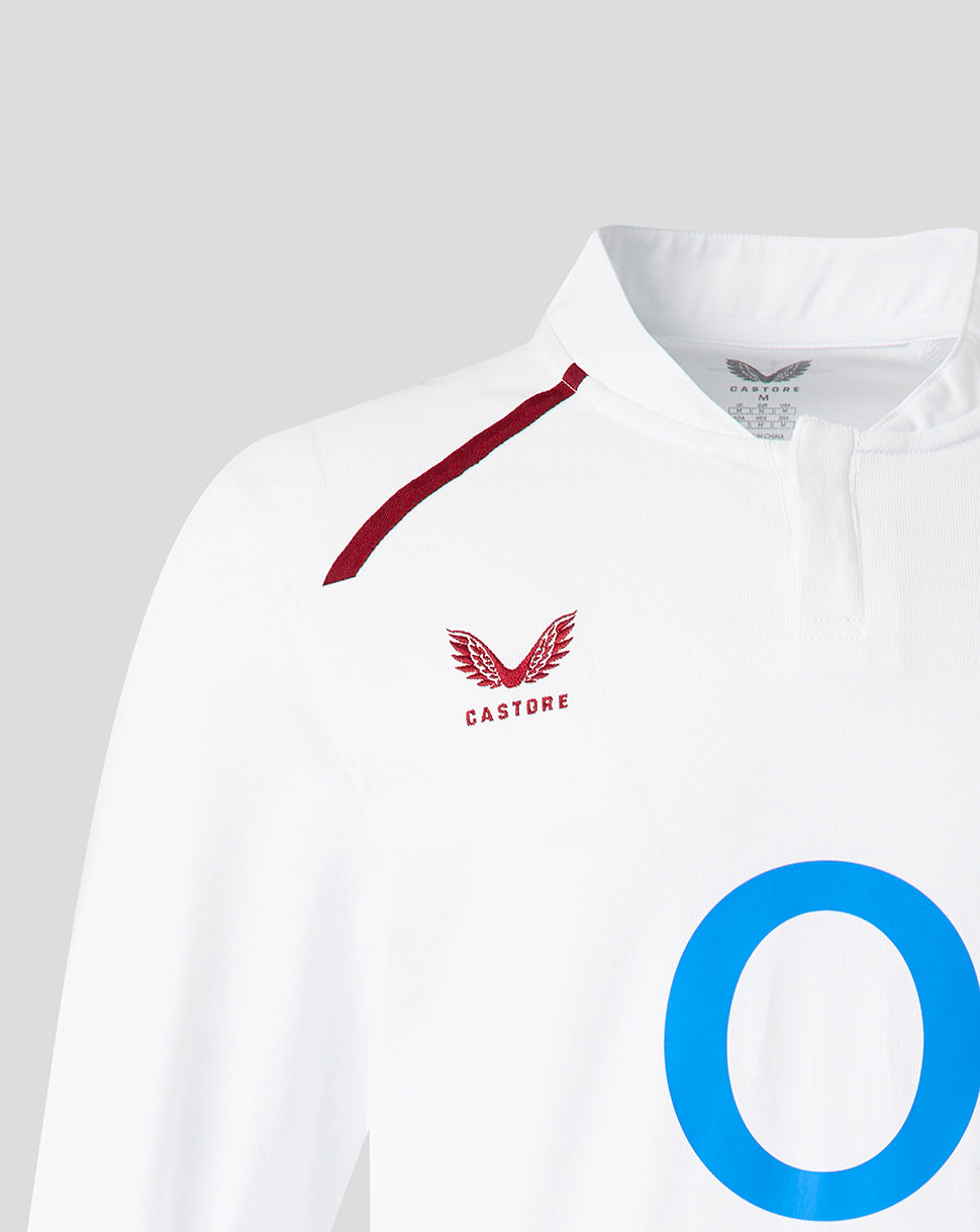Close up of white England Rugby Women's home long sleeve shirt with red shoulder stripe rose crest and large blue sponsor circle.