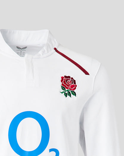 Close up of white England Rugby Women's home shirt showing the chest rose crest and red shoulder trim.