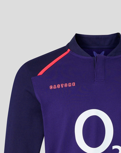 Upper chest and shoulder view of Rhodonite alternate long sleeve rugby shirt with red shoulder piping and pink Castore branding.