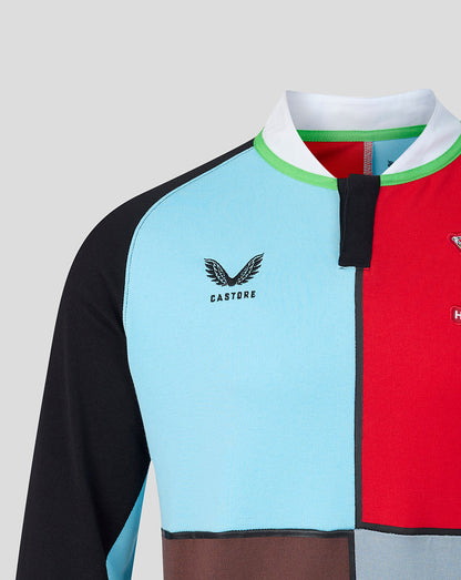 Close up of Harlequins home shirt showing light blue and red color blocks with a white collar and green trim