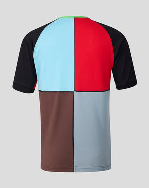 Color-blocked t-shirt with black, blue, red, brown, and gray sections on a light gray background