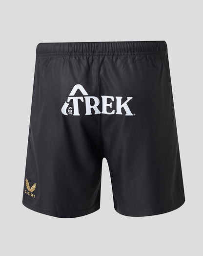 Black athletic shorts with a white Trek logo on the front and a small gold logo on the lower left leg, shown against a light gray background.