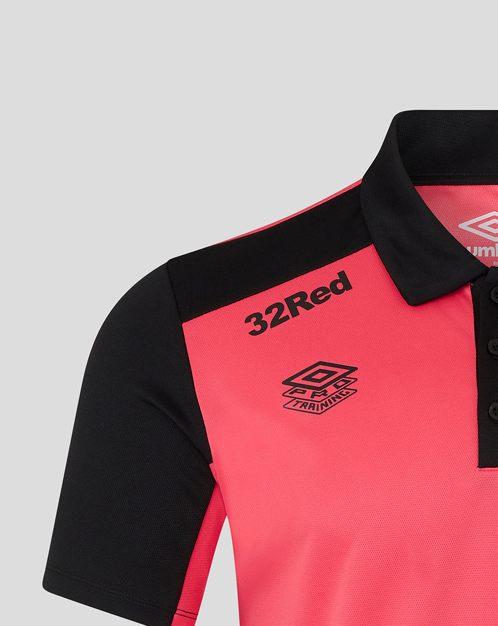 Pink polo shirt with black collar and sleeves, featuring '32Red' and Umbro logos on a light gray background.
