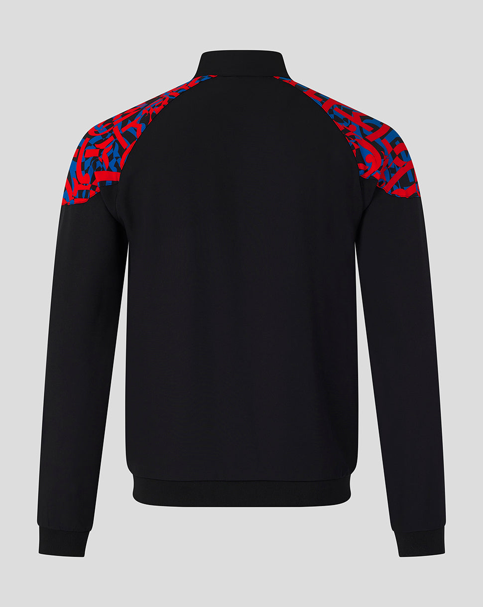 A black long-sleeve quarter-zip sweatshirt shown from the back, featuring a vibrant red and blue abstract patterned yoke on the shoulders, set against a solid light gray background.