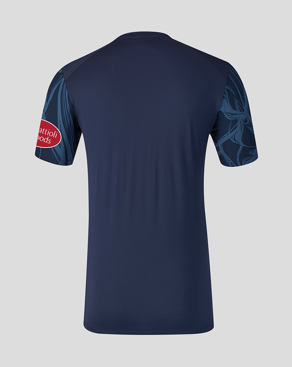 A navy blue short-sleeve athletic jersey shown from the back, featuring a red oval logo on the right sleeve and a tonal dark blue graphic pattern on the left sleeve, set against a solid light gray background.