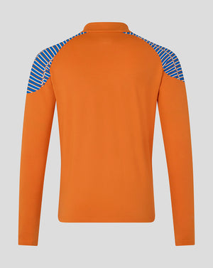 An orange long-sleeve athletic top shown from the back, featuring blue and white diagonal striped panels on the shoulders, set against a solid gray background.