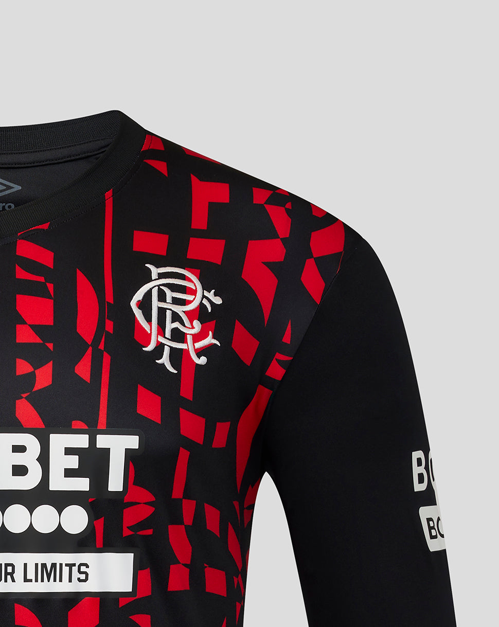 Close-up of a black and red patterned Rangers jersey with the white Rangers crest on the chest, on a light gray background.