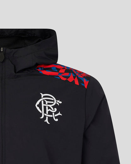 Close-up of a black hooded jacket with a white stylized 'R' logo on the chest and a red and blue geometric pattern across the shoulder, shown on a light gray background.