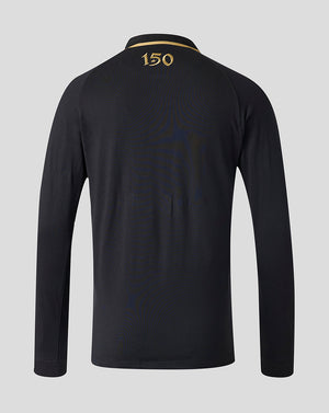 A long-sleeve black polo shirt shown from the back, featuring a gold '150' print on the collar and subtle tonal wave patterns across the back, set against a solid light gray background.