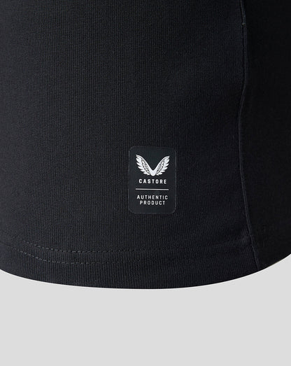 Close-up of a black ribbed knit garment, likely a sweatshirt or jacket, showing a small rectangular Castore Authentic Product patch on the front.
